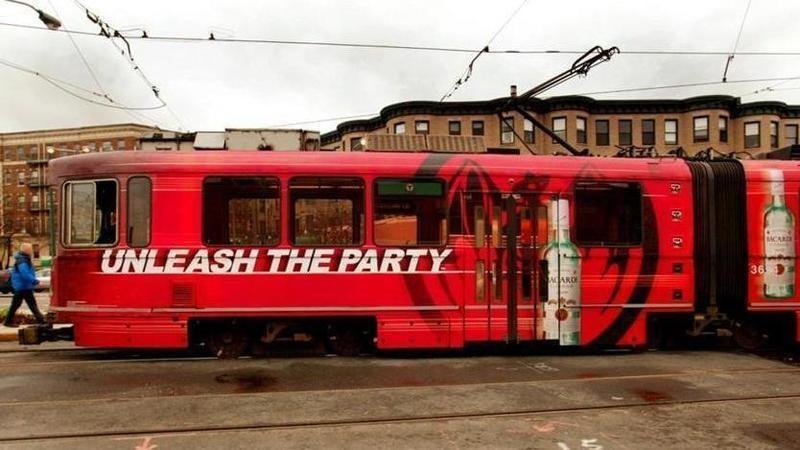 a boston T wrapped in alcohol advertising