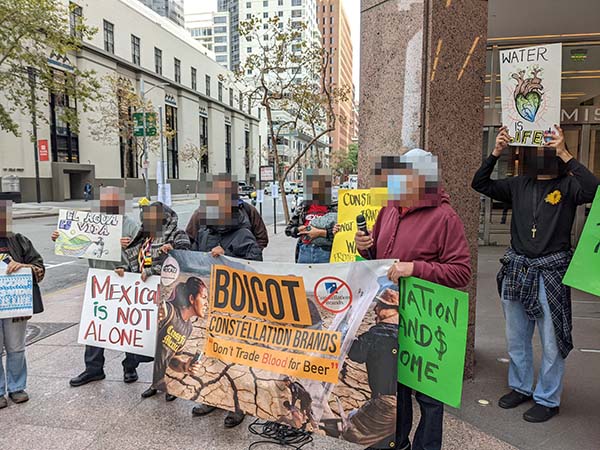 Protestors gather around the Constellation offices at 101 Mission St. in San Francisco