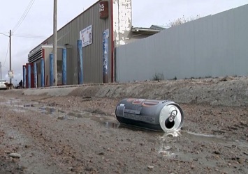 A beer can in a muddy ditch in Whiteclay Nebraska