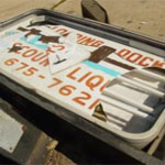 a broken liquor store sign